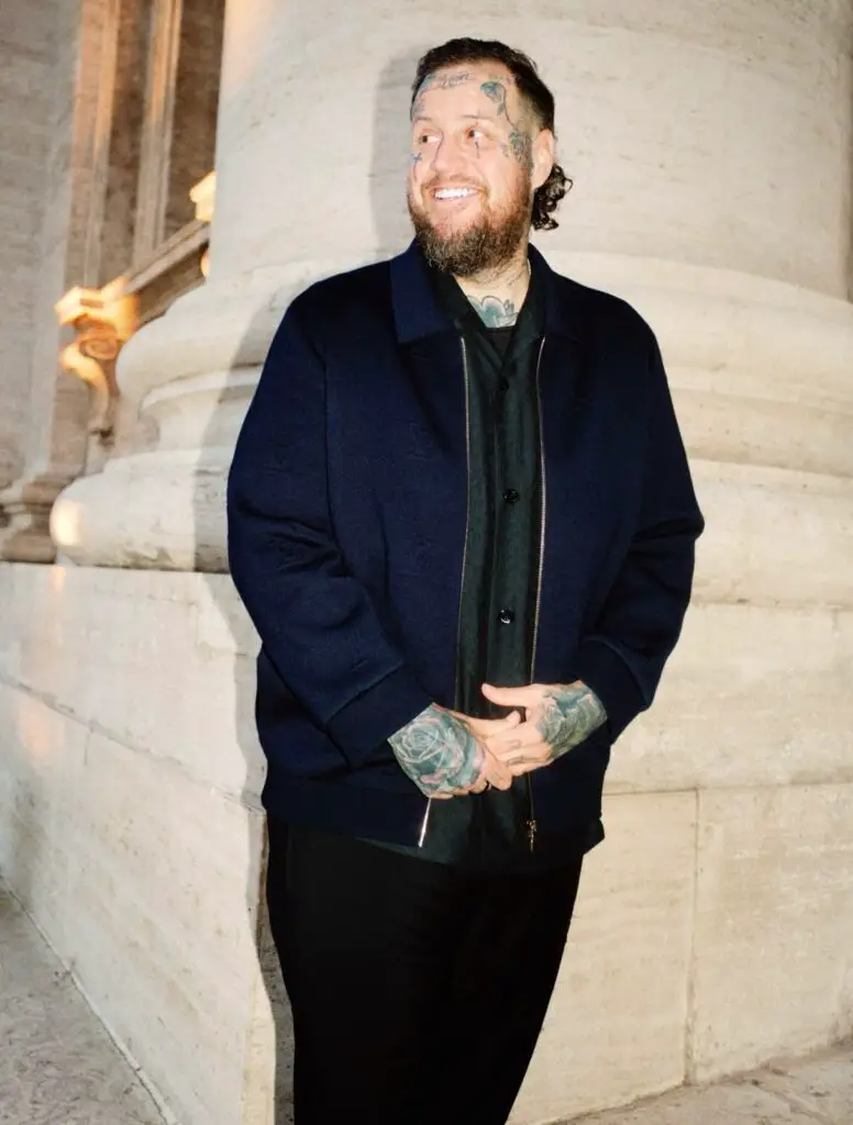 Jelly Roll current weight loss photo 2025 displaying slimmer physique after losing 200 pounds, wearing navy jacket at upscale venue